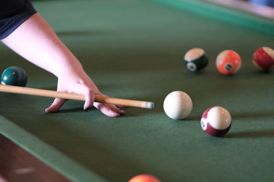 Cropped hand playing pool