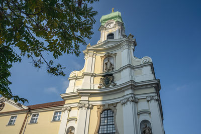 Low angle view of historic building against blue sky