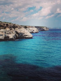 Scenic view of sea against cloudy sky