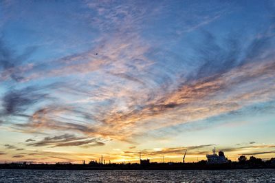 View of harbor against cloudy sky