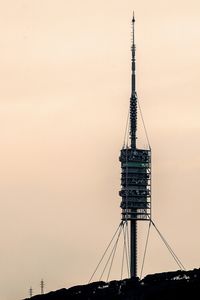 Low angle view of crane at sunset