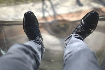 Low section of man standing on tiled floor