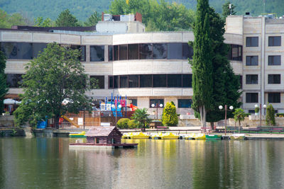 Reflection of trees and buildings in lake