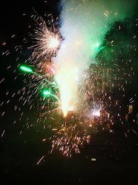 Low angle view of firework display at night