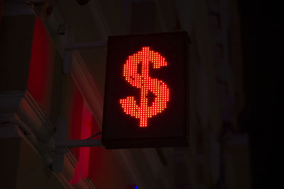 Low angle view of road sign at night