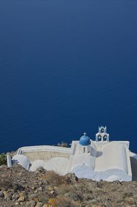 High angle view of sea shore against blue sky