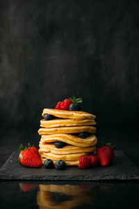 Close-up of strawberries on table against black background