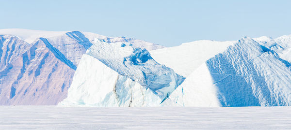 Scenic view of snowcapped mountains against clear sky