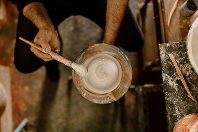 Cropped hand of man working at workshop