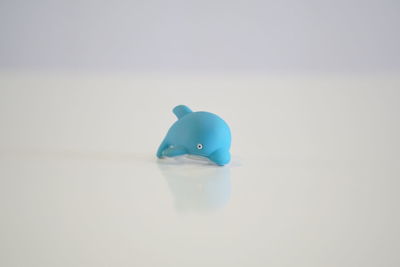 Close-up of blue toy over white background