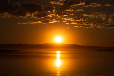 Scenic view of sea against romantic sky at sunset