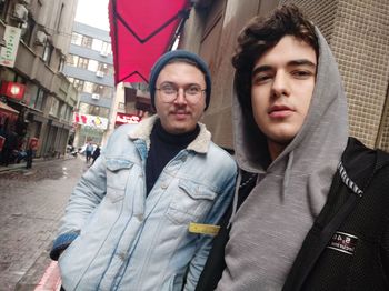 Portrait of man and man on street in city