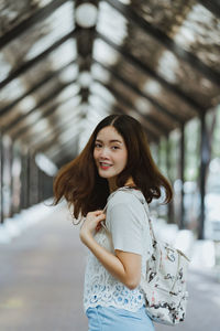 Portrait of smiling young woman standing outdoors