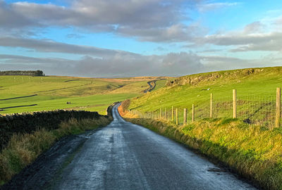 Winter sunlight, over bank lane, with dry stone walls, fields, and moorland near, silsden, uk