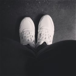 Close-up of shoes on tiled floor