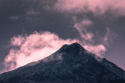 Low angle view of volcanic mountain against sky