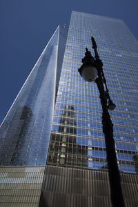 Low angle view of modern building against clear blue sky