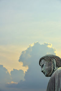 Superimposed of the great buddha of kamakura town, japan with dramatic and peaceful clouds.