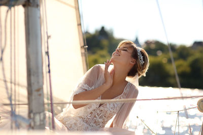 Bride on a sailing yacht in the rays of the setting sun