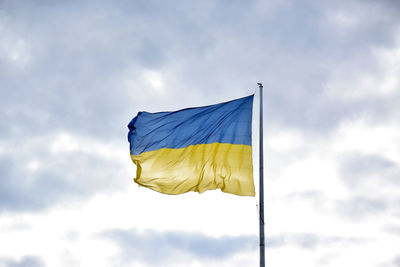 Low angle view of flag against sky