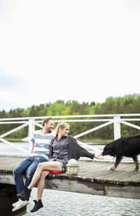 Couple with dog on pier