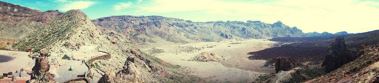 mountain, scenics, tranquil scene, tranquility, beauty in nature, sky, beach, sand, rock formation, nature, sea, water, mountain range, landscape, physical geography, geology, panoramic, cliff, tourism, high angle view