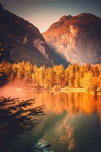 Scenic view of lake by trees against sky during autumn