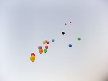 Low angle view of balloons against sky