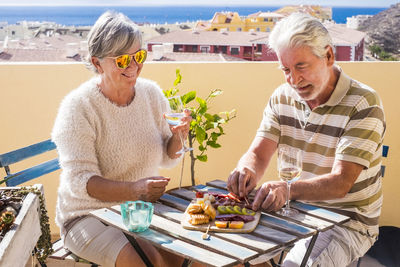 Senior couple having food at outdoors restaurant