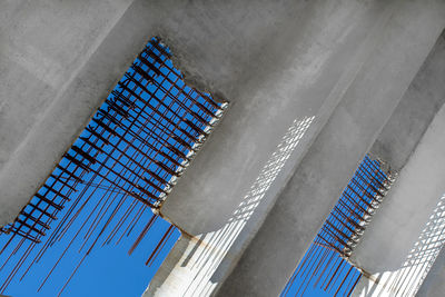 Low angle view of modern building against blue sky