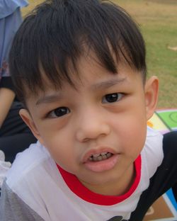 Close-up portrait of cute boy smiling