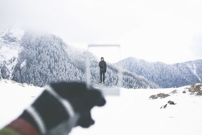 People standing on snow covered landscape