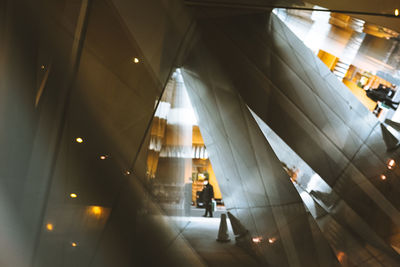 Low angle view of escalator in illuminated building