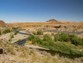 Scenic view of arid landscape against clear sky