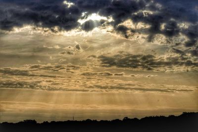 Scenic view of silhouette landscape against dramatic sky