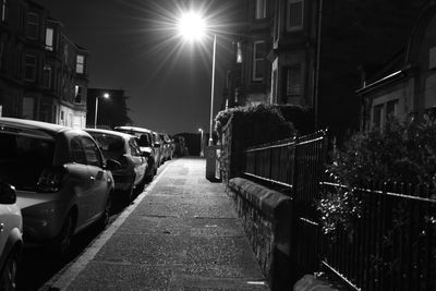 Cars on illuminated street at night