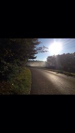 Road by landscape against sky