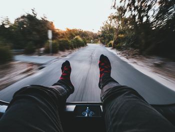 Low section of person standing on road