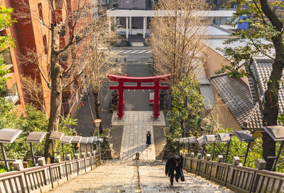 People walking in park by building