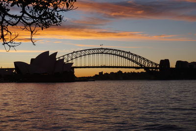Bridge over river during sunset