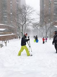 People skiing on snow covered tree