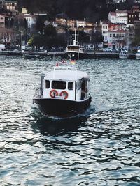 Boats in river with buildings in background