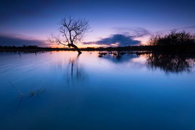 Scenic view of lake against sky during sunset