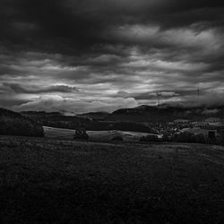 Scenic view of field against cloudy sky