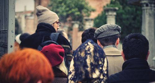 Rear view of people against blurred background