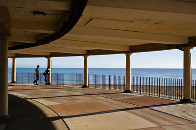 Man standing by sea against sky