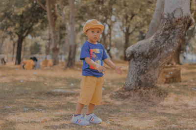 Full length of boy standing on field
