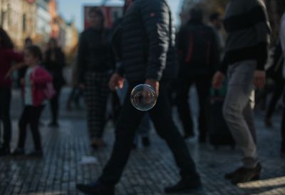 Bubble against people walking on footpath