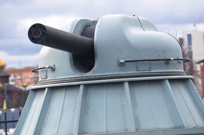 Close-up of coin-operated binoculars against sky in city