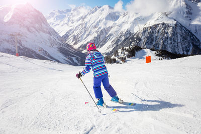 Full length of man skiing on snowcapped mountain